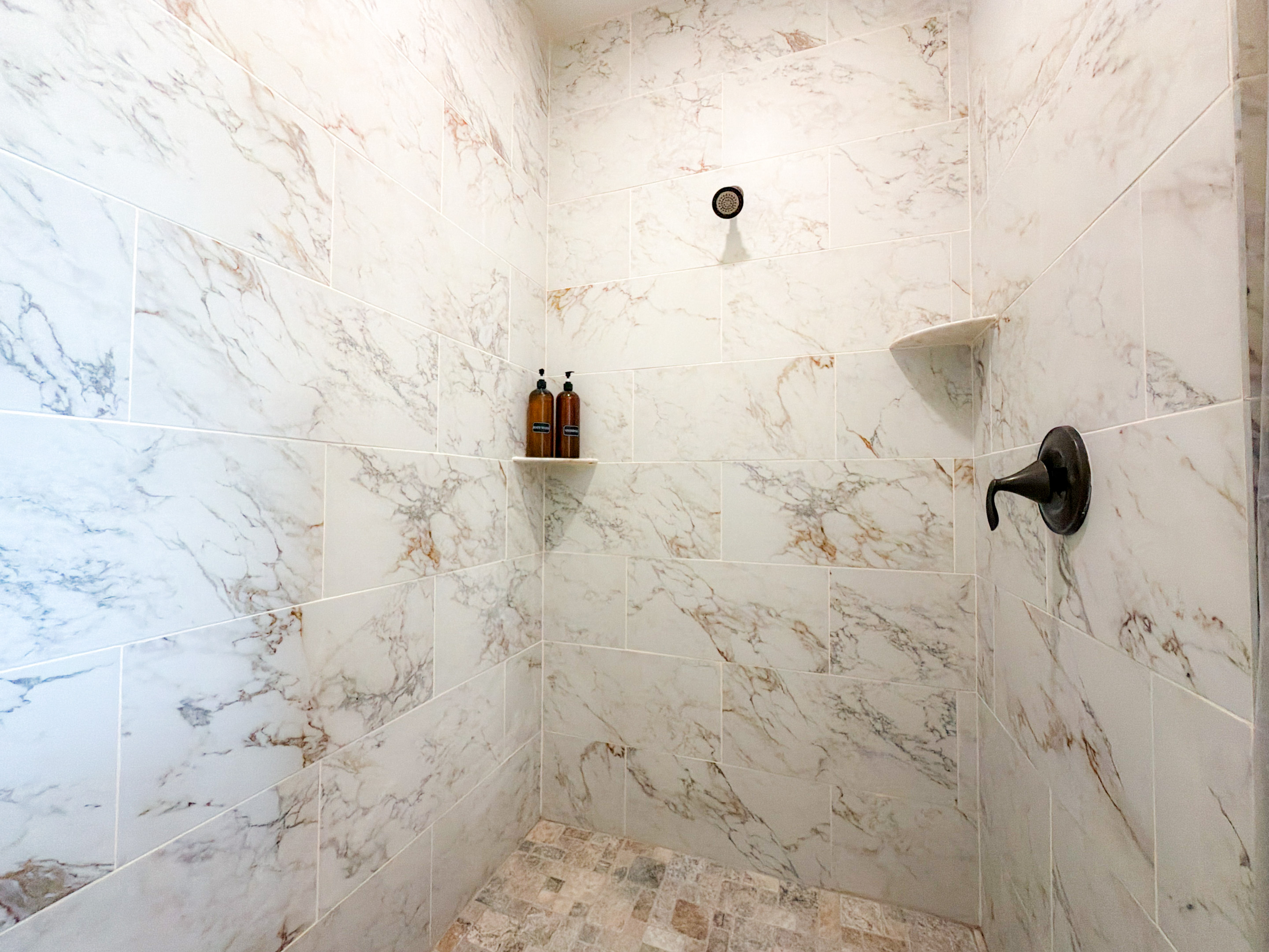 full tile and marble master suite bathroom.