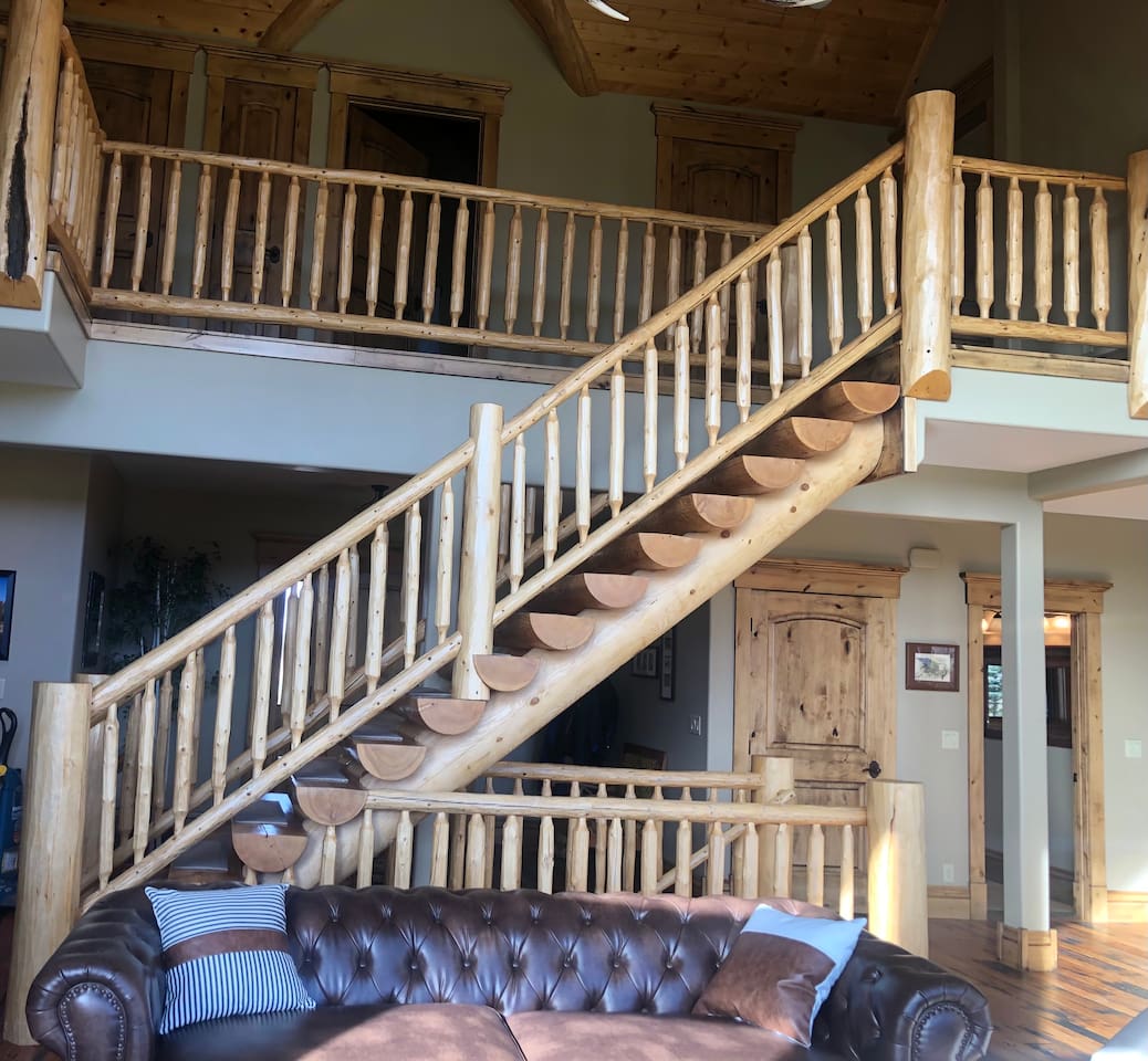 Become emersed in the West!  Take in the stunning details of this open-concept space, highlighted by a handcrafted log staircase and lofted upper level—bringing rustic elegance and a true lodge-style experience to the heart of the home.