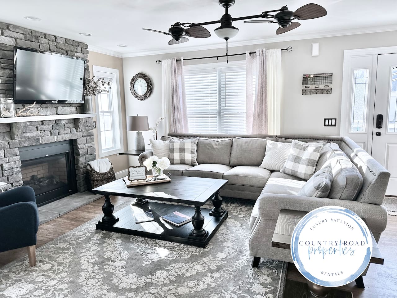 This living room is all about comfort. The big, plush sectional is perfect for sinking into, and the stone fireplace makes the whole room feel so warm and inviting. It’s a bright, open space where you can really just kick back and relax.