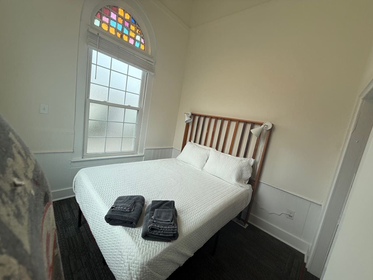 Inviting front bedroom with a comfortable queen-size bed, crisp linens, soft lighting, and all the must-have amenities for a relaxing retreat.