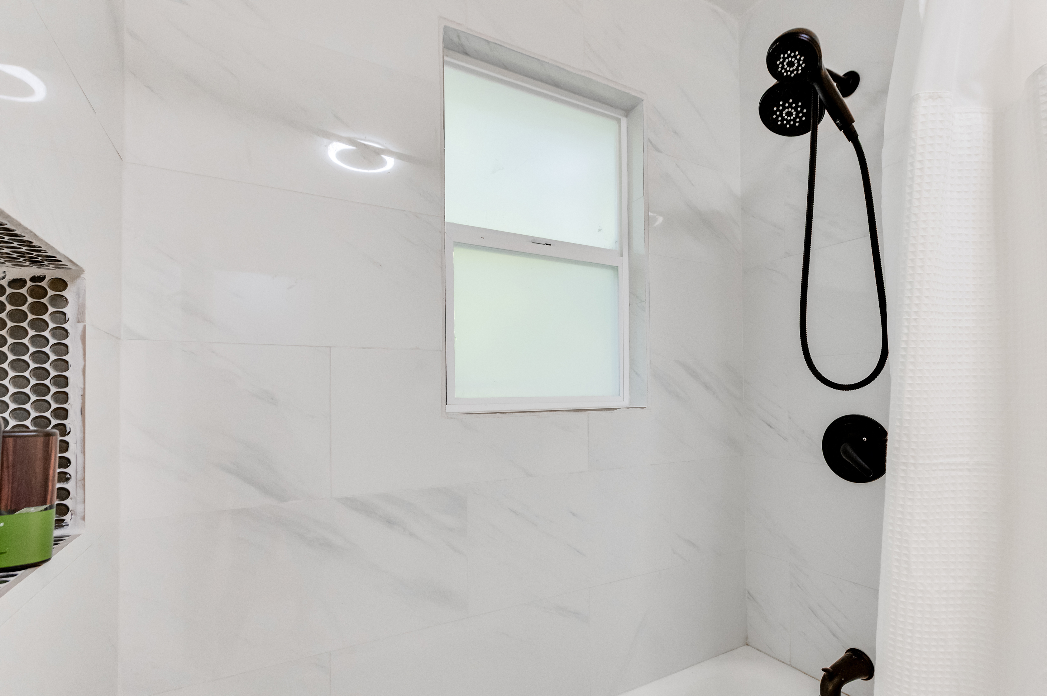 Upstairs Full Bathroom 1: Enjoy a refreshing escape in this beautifully tiled, light-filled shower! All bath essentials are provided.