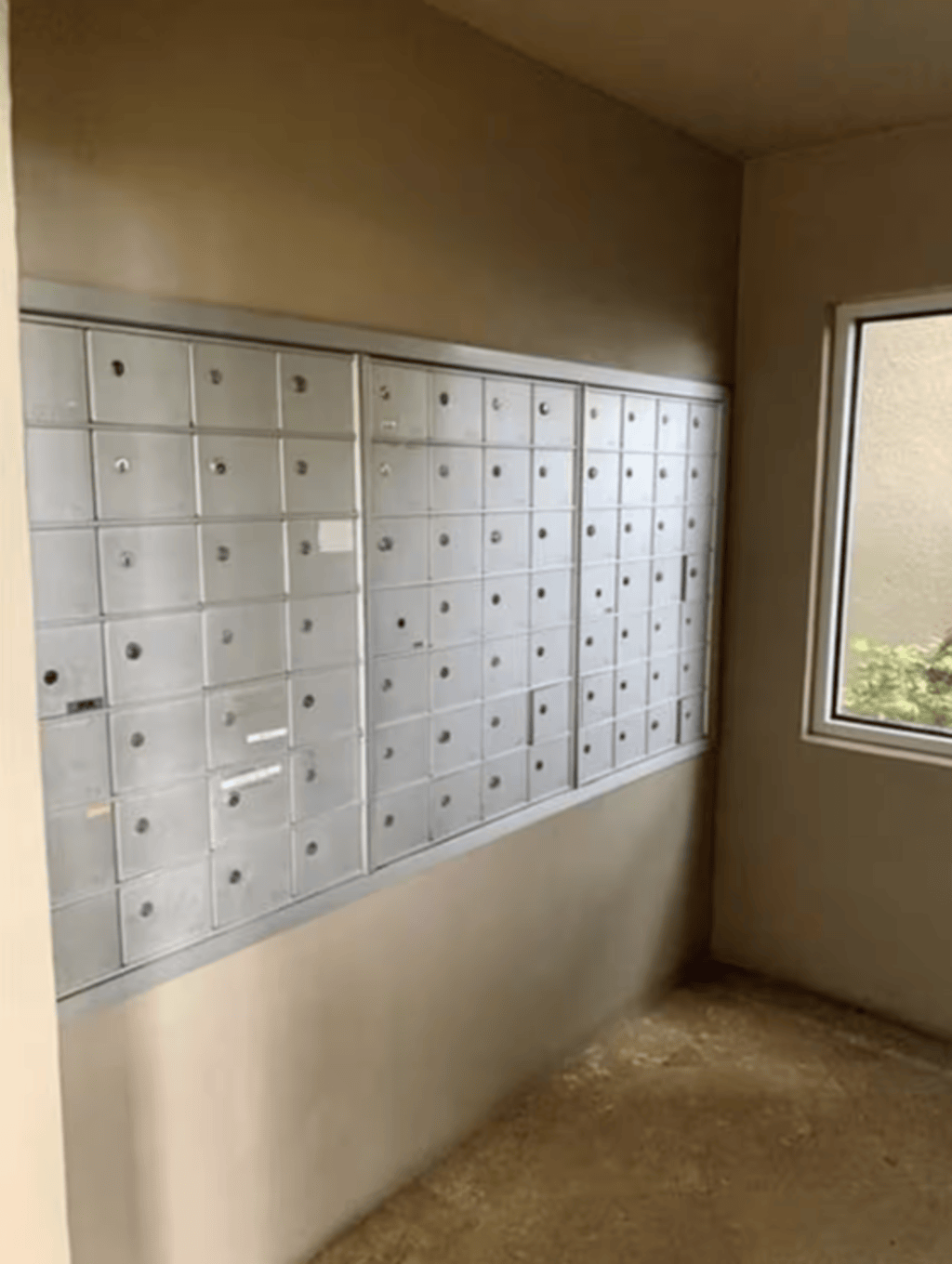 The mailroom is downstairs towards the end of the long hallway entrance.