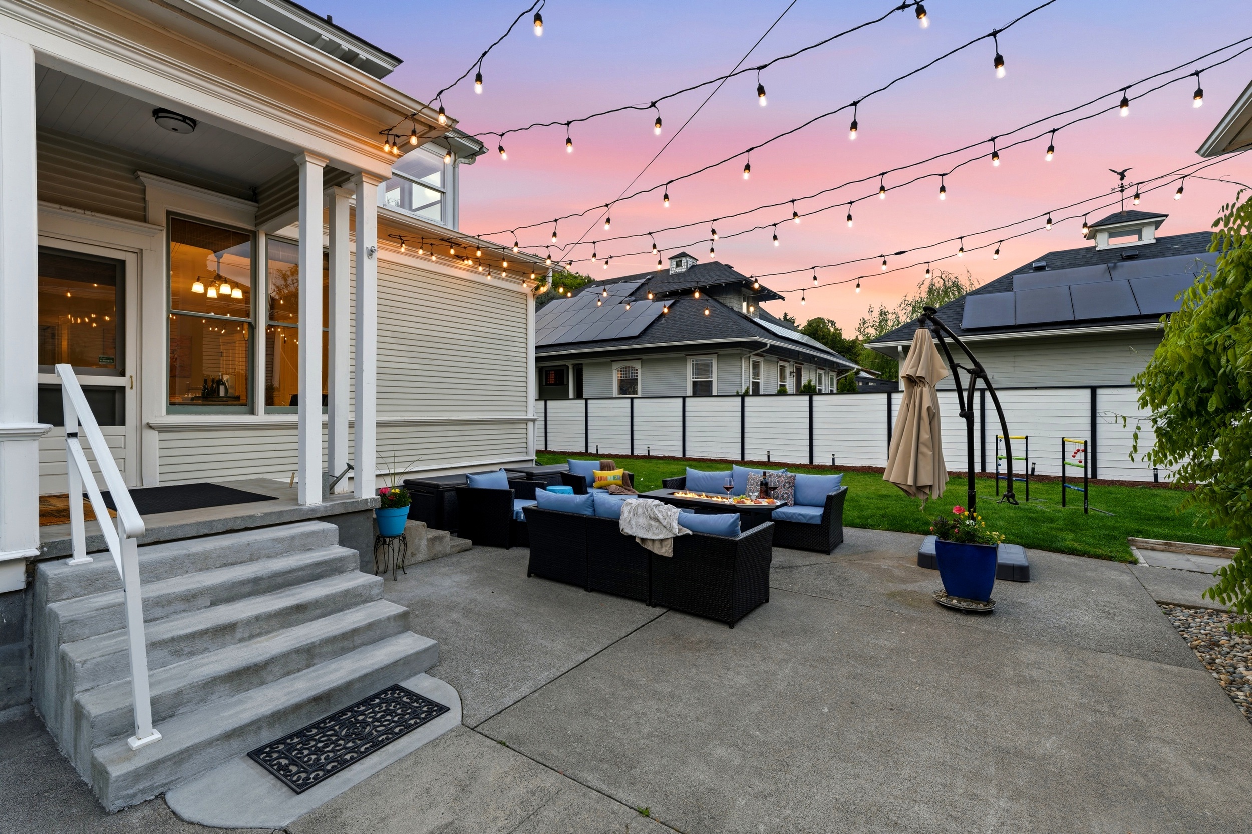 Back patio, surrounded by mature trees and historic charm and equipped with lounge seating and BBQ (propane provided)