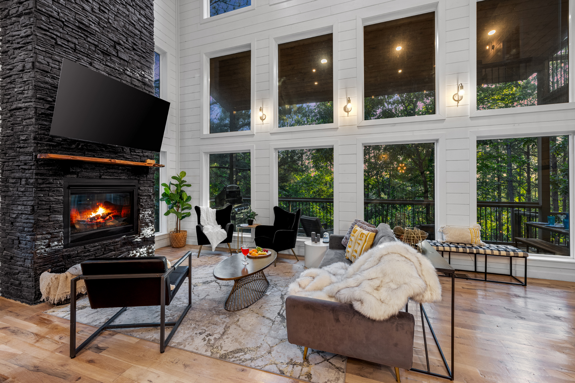 A welcoming main lounge with soft seating, a fireplace, and TV — perfect for relaxing evenings in.