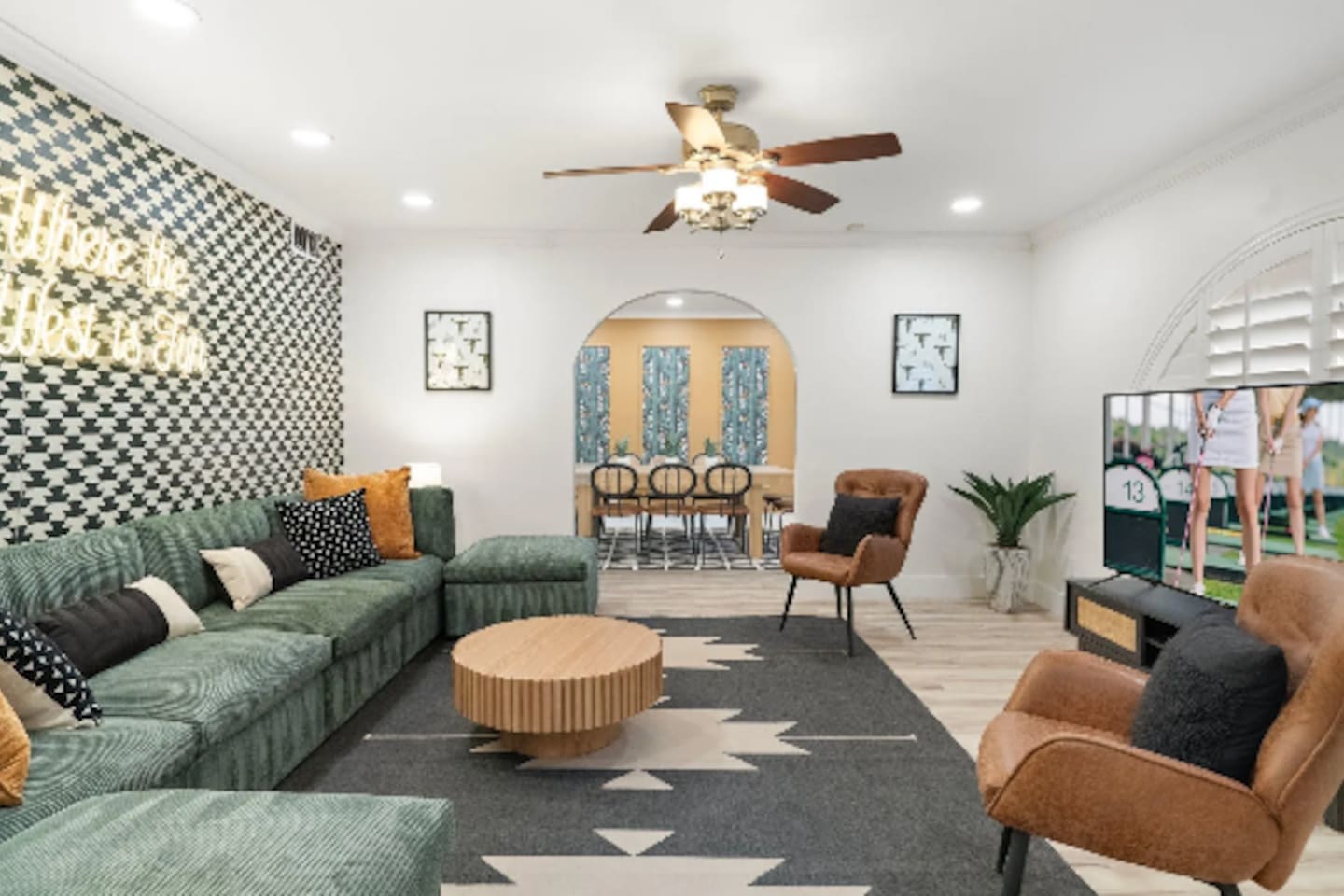 The living room flows straight into a sun-drenched dining nook, so the group never really splits up between lounging and dinner. Curl into the oversized sectional, soak up the neon glow, and let the night stretch on a little longer.