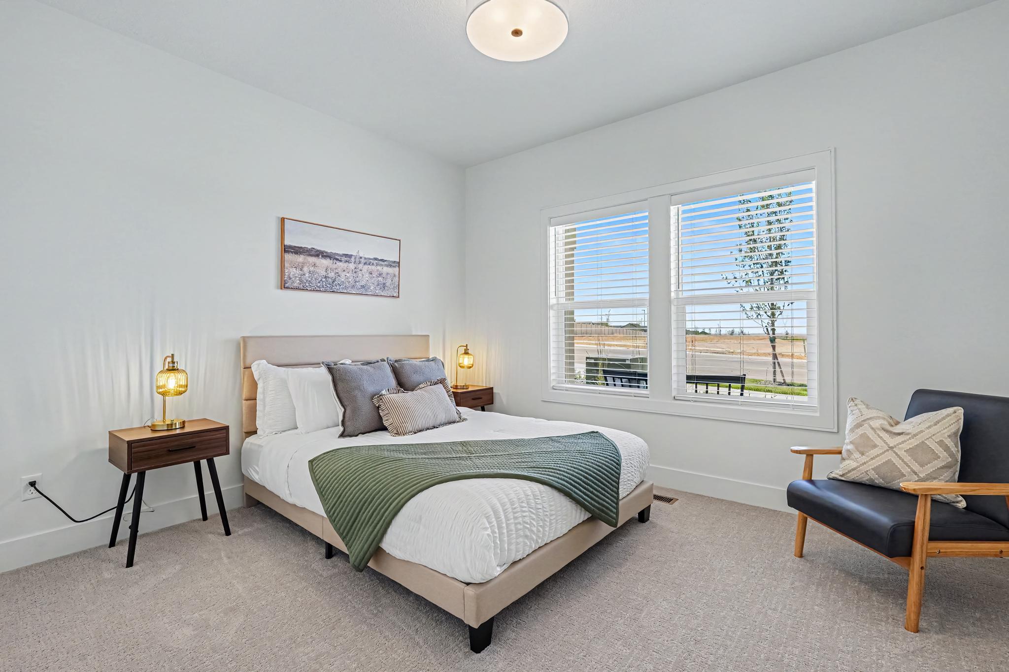 Comfortable front bedroom featuring a relaxing queen bed and a cozy space to unwind.