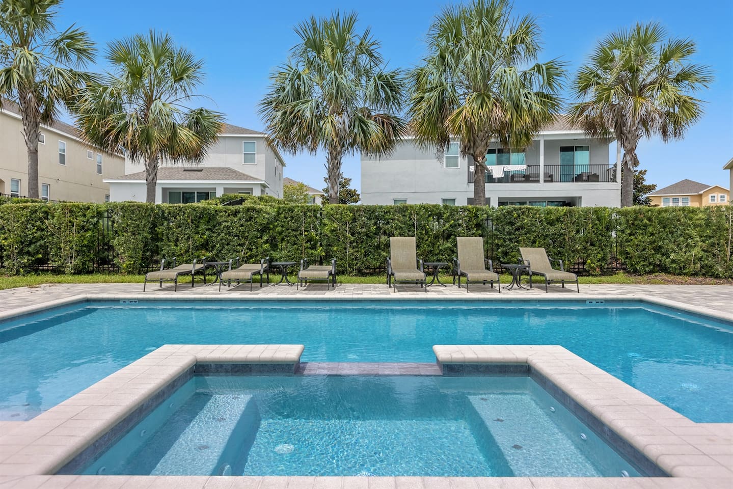 The hot tub is nestled in a serene outdoor setting, surrounded by lush greenery. Its bubbling water glistens under soft, ambient lighting.