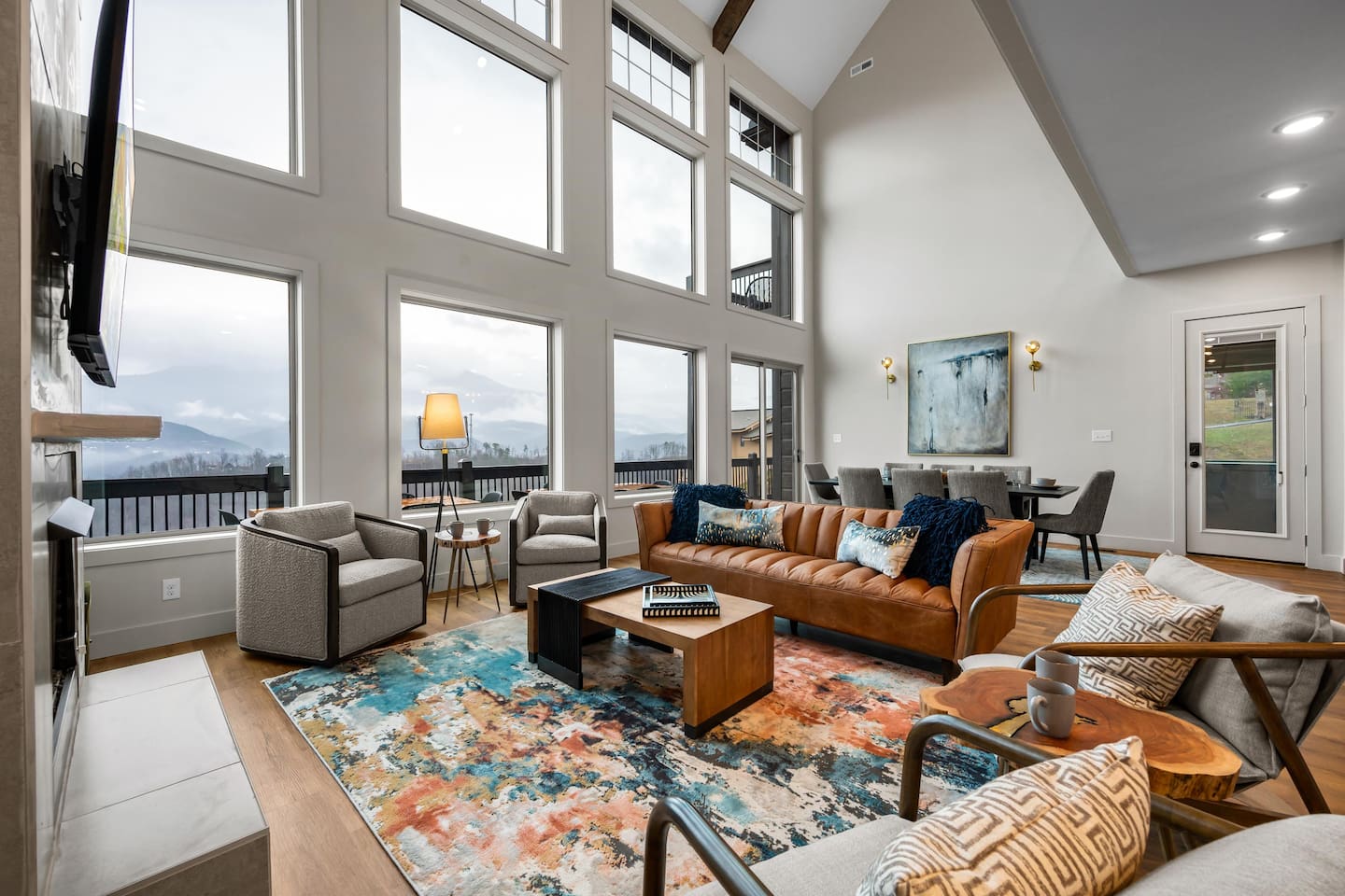 Gatlinburg Airbnb with inviting entry-level living room featuring cozy seating, modern decor, and natural light. Perfect for relaxing after exploring downtown Gatlinburg, Pigeon Forge & Great Smoky Mountains National Park. 