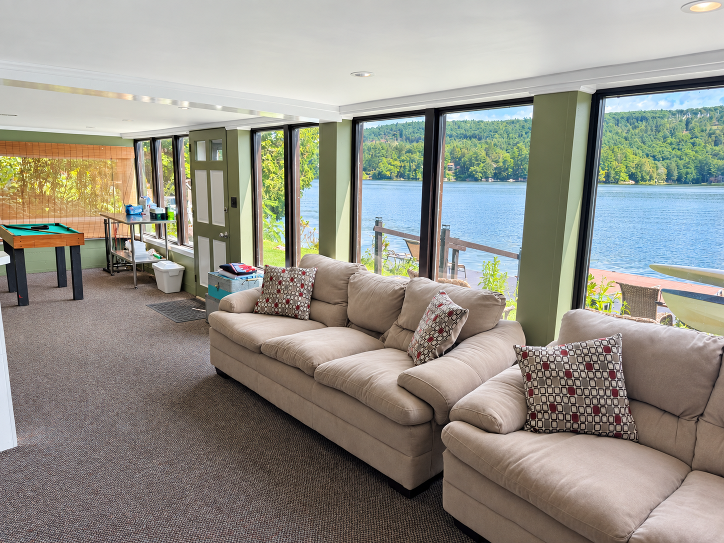 Peaceful lake views the full length of the lower level game room