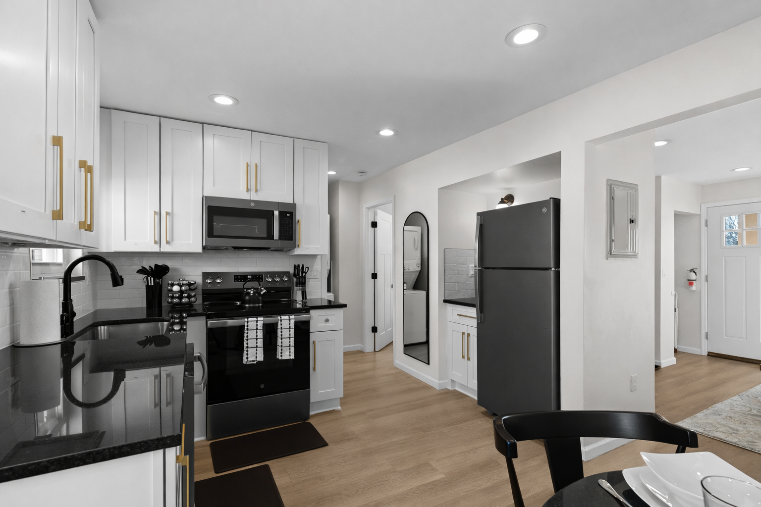 Sleek, modern kitchen with crisp white cabinetry, stainless appliances, and ample counter space—perfect for cooking, hosting, and everyday convenience.