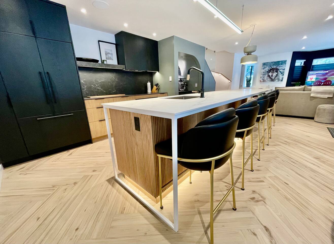 14ft kitchen island w/heated countertop & counter seating for 8 ppl. Fisher Paykel Refrigerator w/Icemaker, Induction cooktop, Convection oven & Dual DishDrawers dishwasher, drink fridge & coffee station, all integrated in custom oak cabinetry.