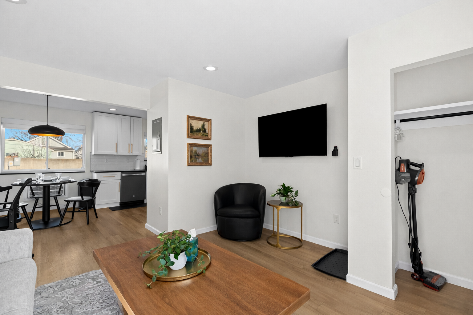 Relax in this bright, modern living space with cozy seating, smart TV, and an open layout that flows seamlessly into the dining area and kitchen.