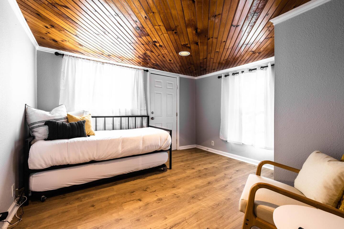 A twin bedroom with a trundle pullout offers flexible sleeping arrangements, perfect for kids or extra guests.