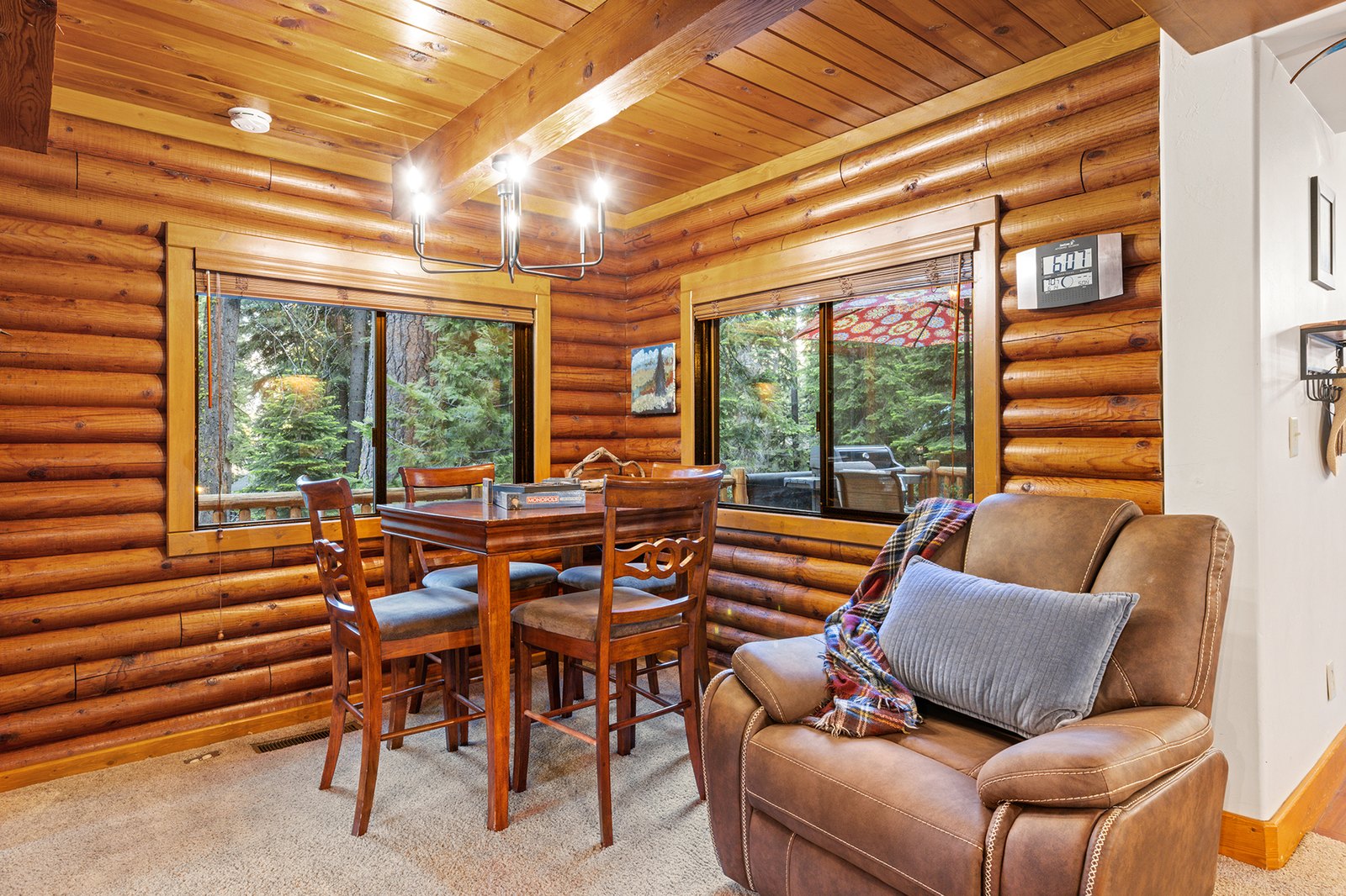 Pull up to the game table by the window — cards, puzzles, and a view of the pines between turns.