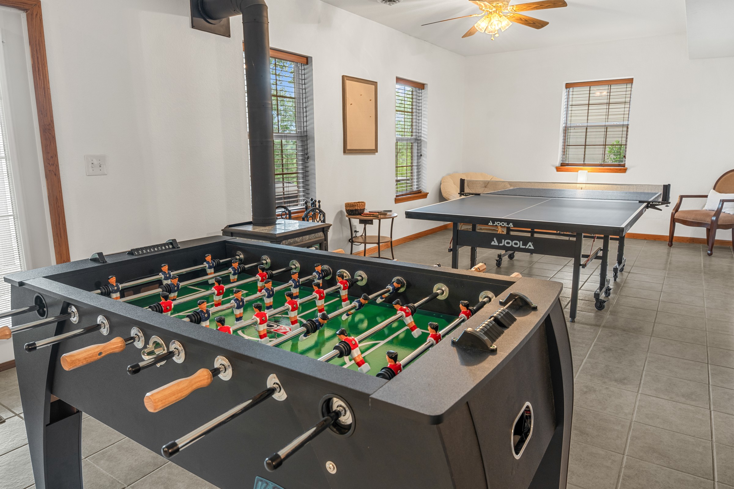 Foosball table in front of the ping pong table in the game room. Pick a side, ya'll, and let the tournament begin.