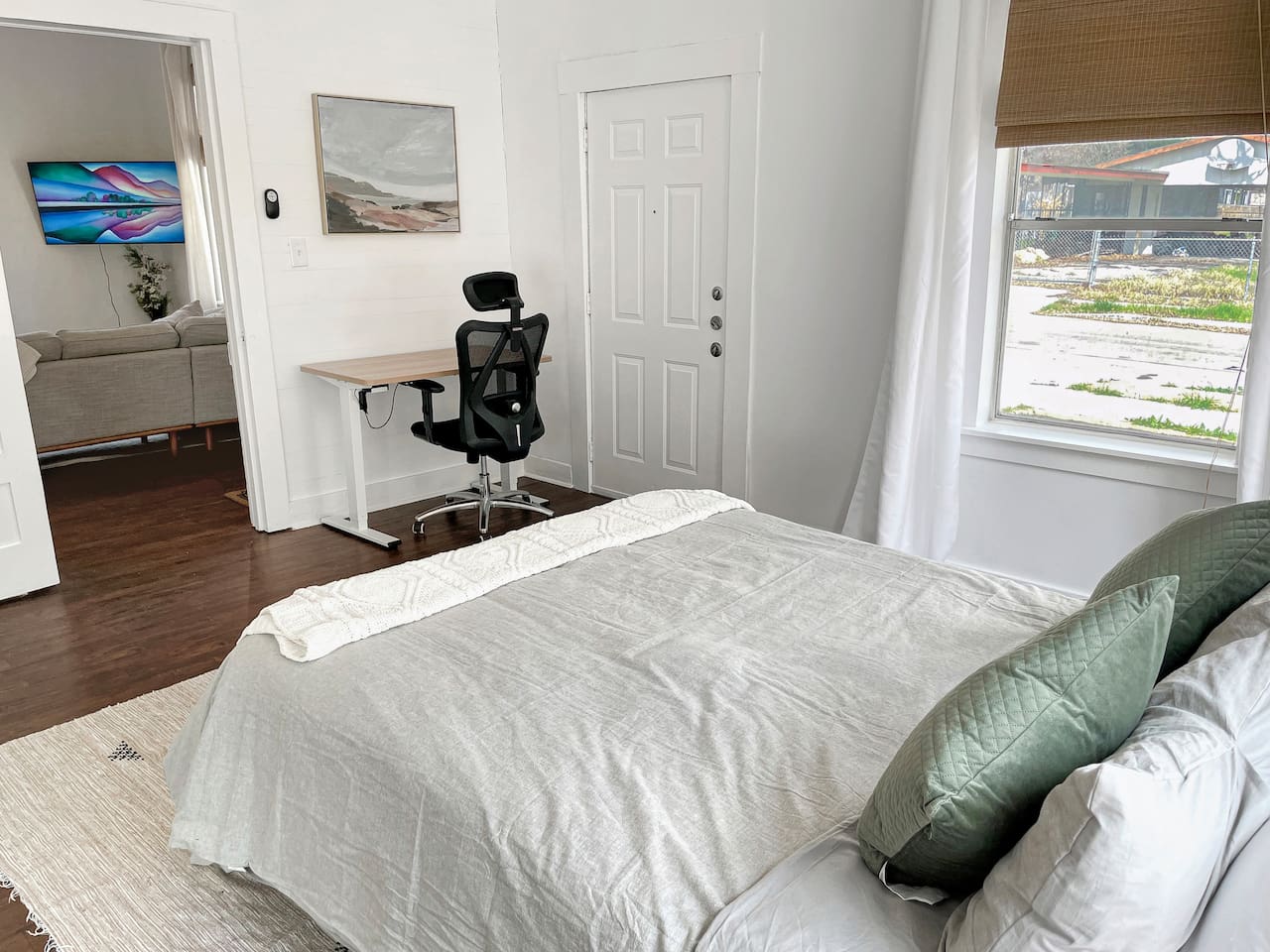 The front bedroom is off of the main living room and includes a large mirror and closet. The external door by the desk is not in use and fully bolted.