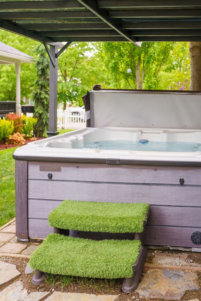 Rain or shine, vacation mode is on! Enjoy a soak in this large Cal Spa hot tub, thoughtfully covered by a gazebo for all-weather comfort and designed with a privacy flip top.