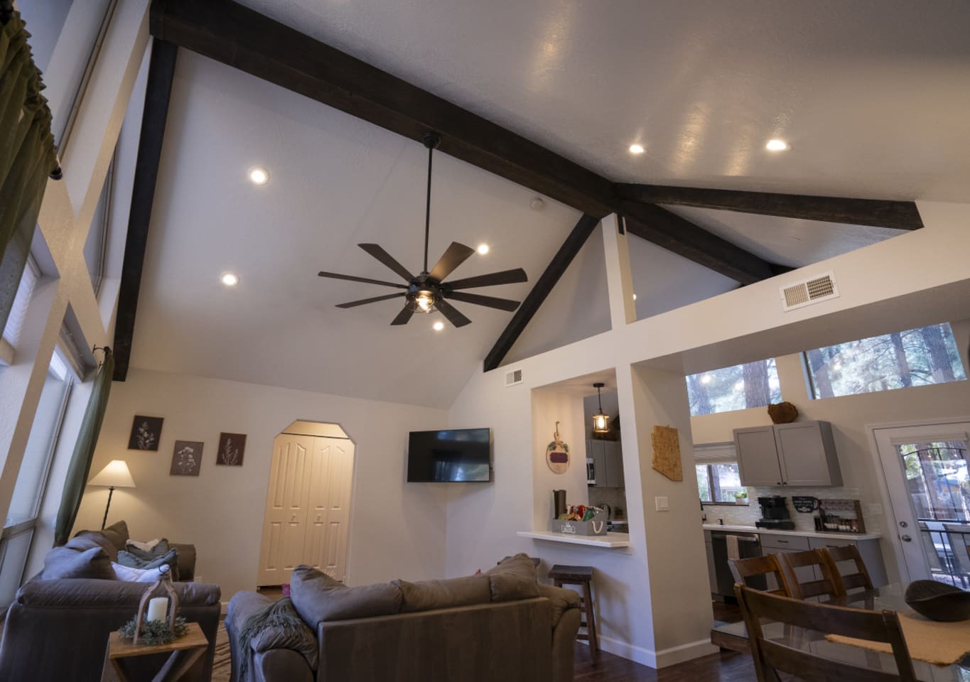 Open living space with tall windows, natural light, and a cozy setup for gathering after a day out.