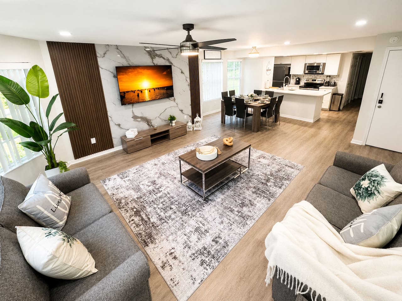 Spacious open-concept living area with comfortable seating and a TV.