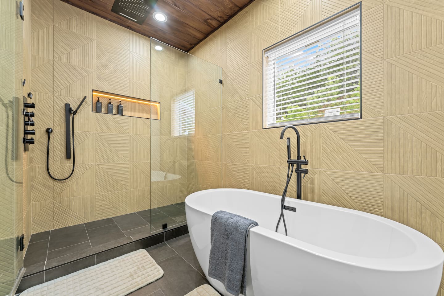 master bathroom with soaking tub and waterfall shower head