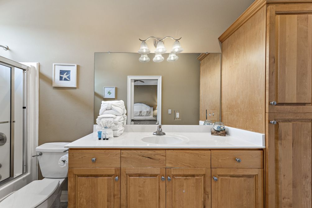Bathroom vanity with wood cabinetry and mirror