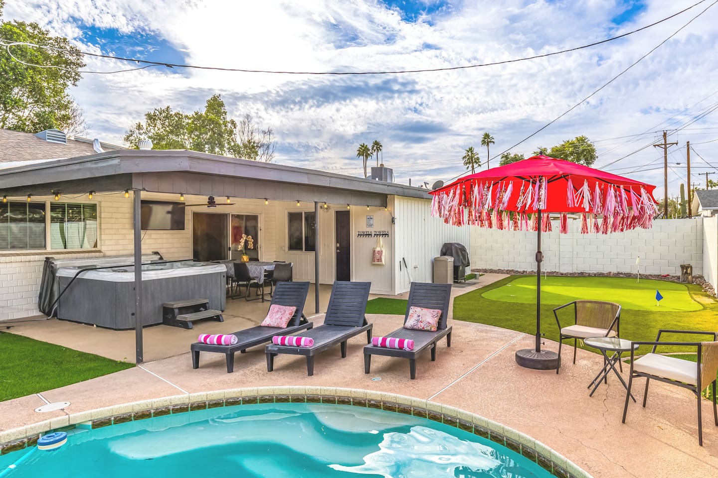 Catch rays or nap poolside on plush loungers with rolled towels and playful pillows—your Scottsdale getaway starts here.

