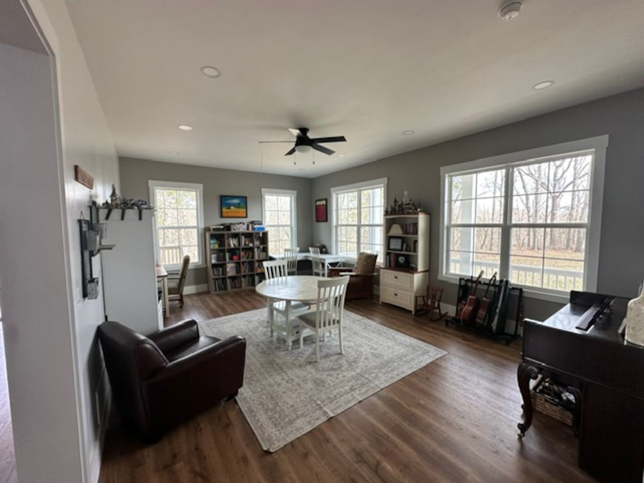 Our library features three work spaces, two comfy chairs for reading, PLENTY of books (we love the classics!), children's art supplies & crafts, as well as a piano and a few guitars. Beautiful views from these windows too. Open to living room/foyer.