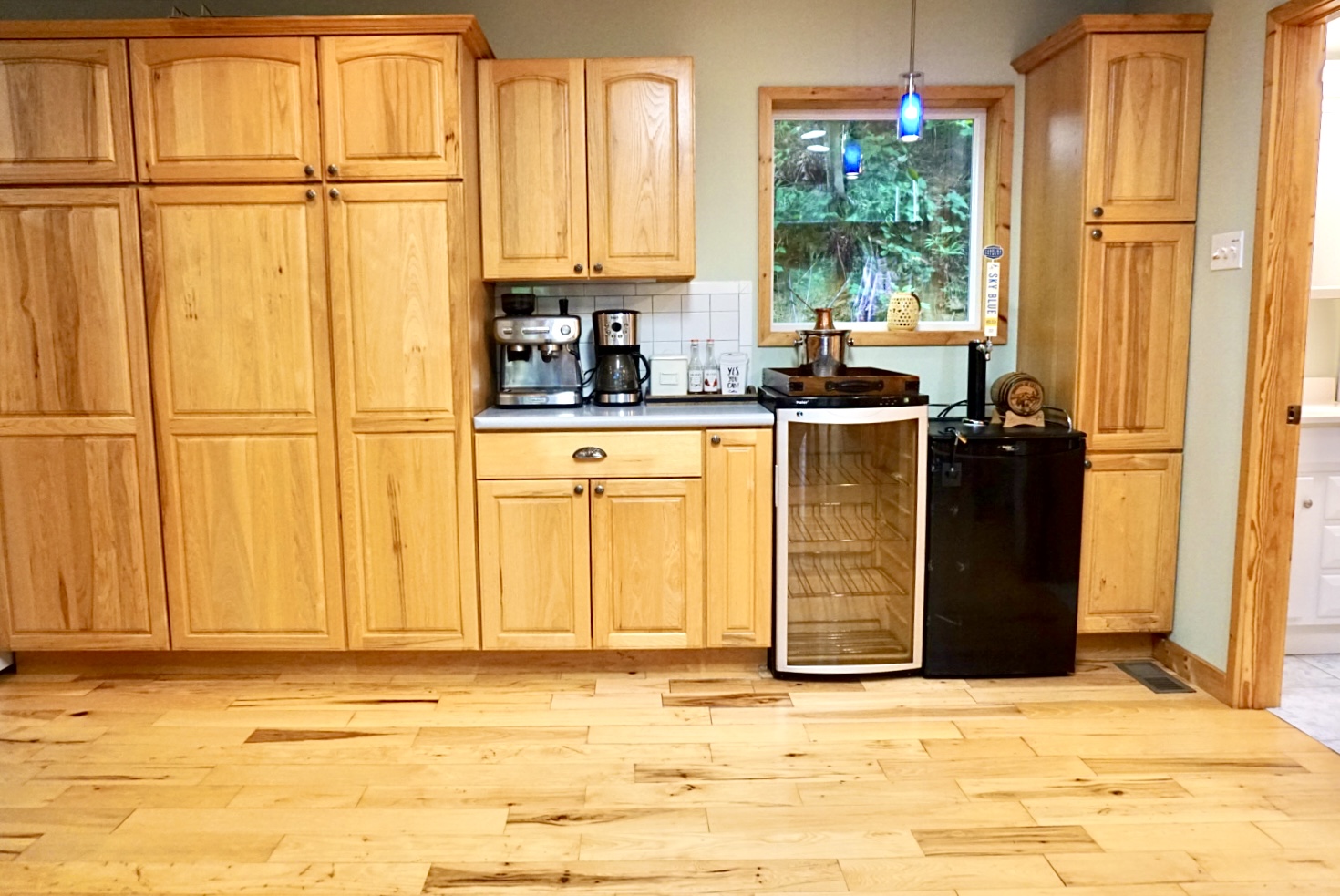 Whip up culinary delights in this sunlit wood-filled kitchen with modern appliances!