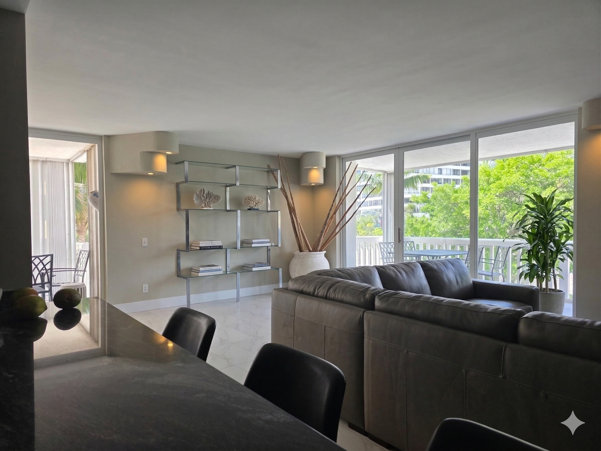 Living room with two balconies-one walks out to the pool/ocean in 2 minutes! Second balcony overlooks the street in front of the building. This unit is a corner unit.