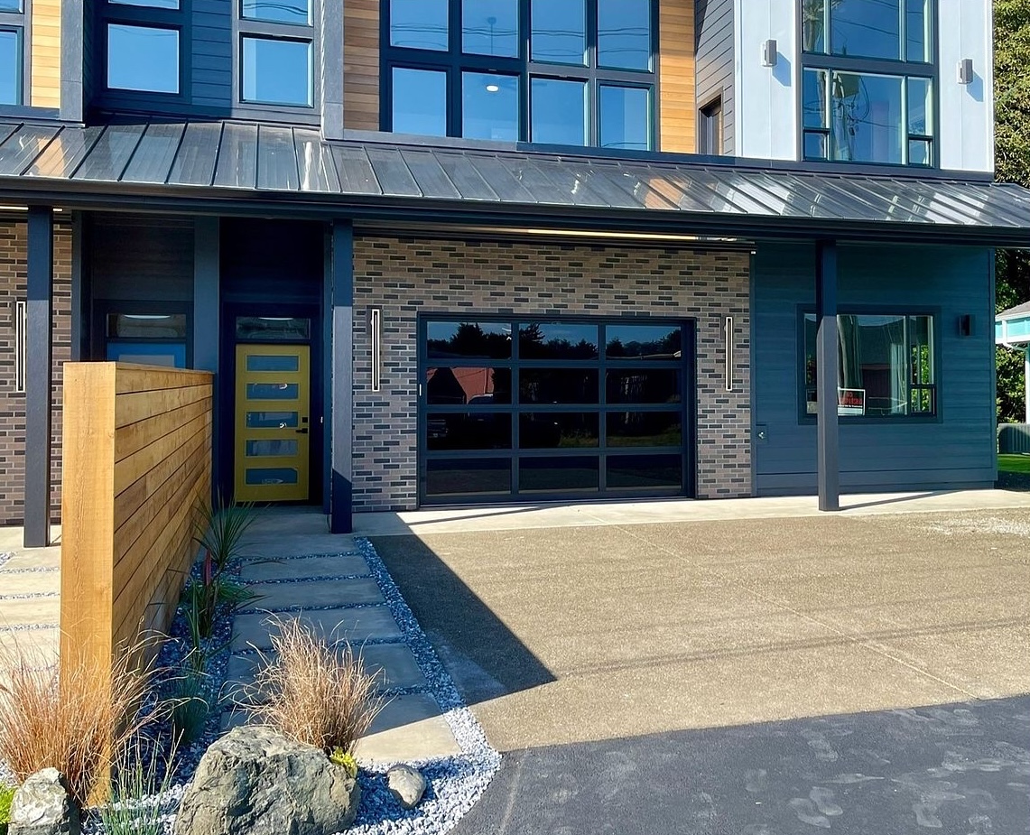 Bold modern curb appeal — designer door, warm wood fencing and a private driveway. Side B has its own entrance and its own parking, completely separate from Side A.