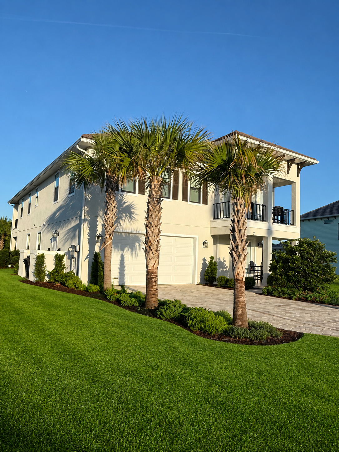 Three tall palms stand guard over your home away from home. Pull into the drive, unload the beach gear, fling open the doors—this is the happy chaos of arrival, the first deep breath of a week that already feels like it will be unforgettable.