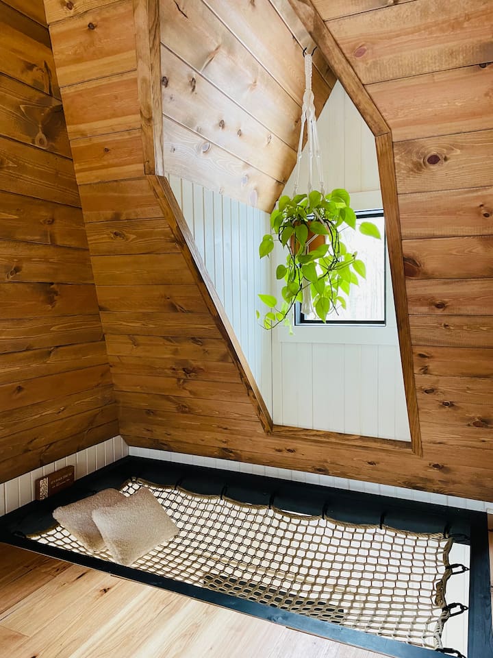 This dreamy second-story loft is accessible only by a ship’s ladder, adding an adventurous yet intimate feel.