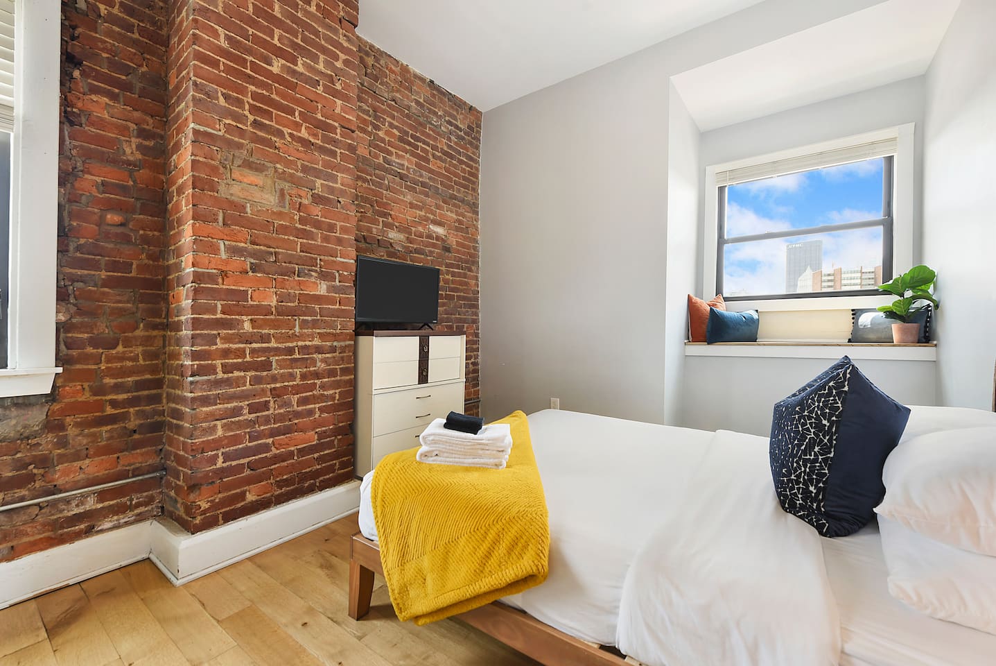 Spacious and elegant queen-sized bedroom with TV designed for comfort and style.