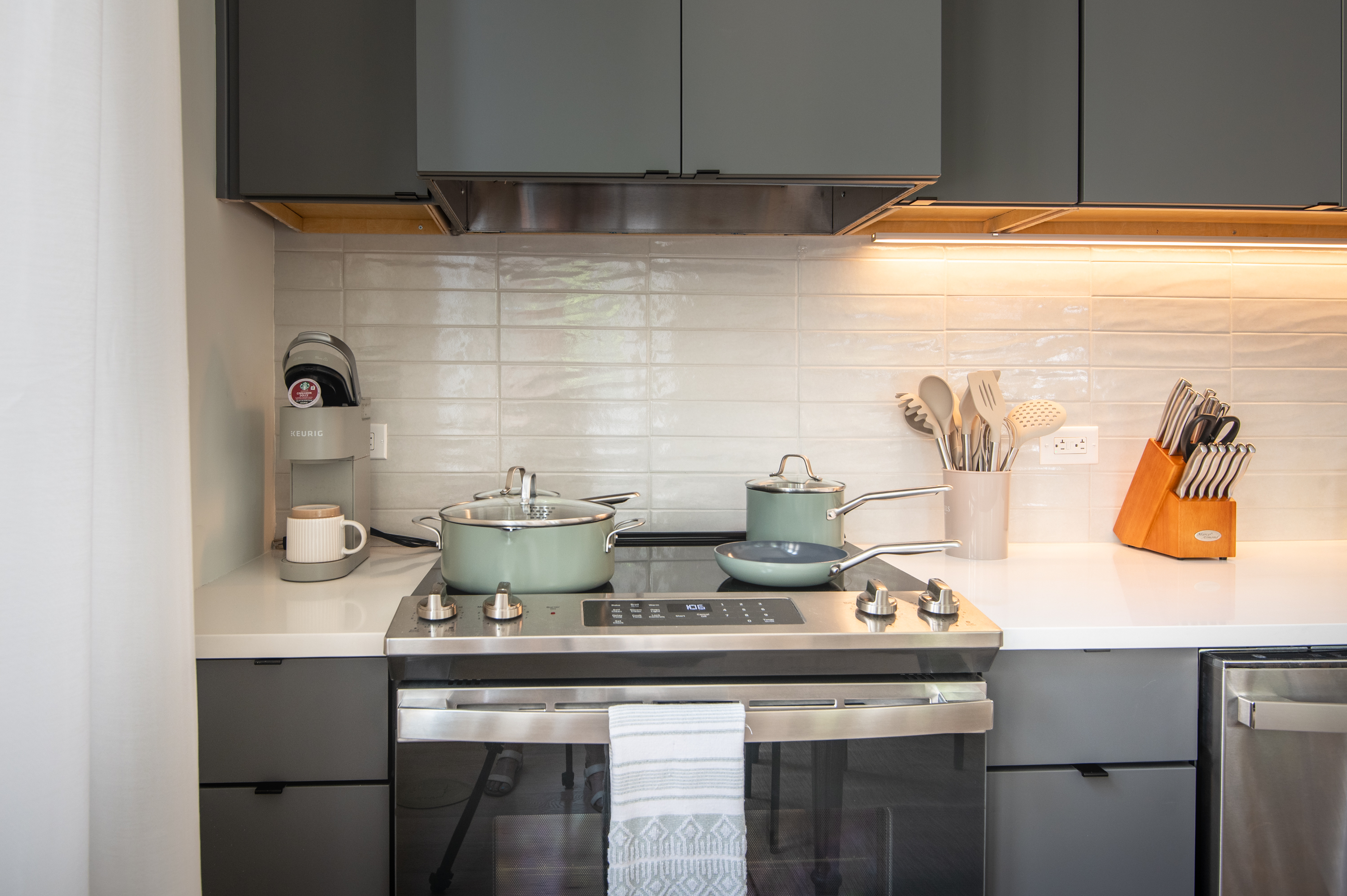 Fully equipped kitchen with stove, cookware, and essentials