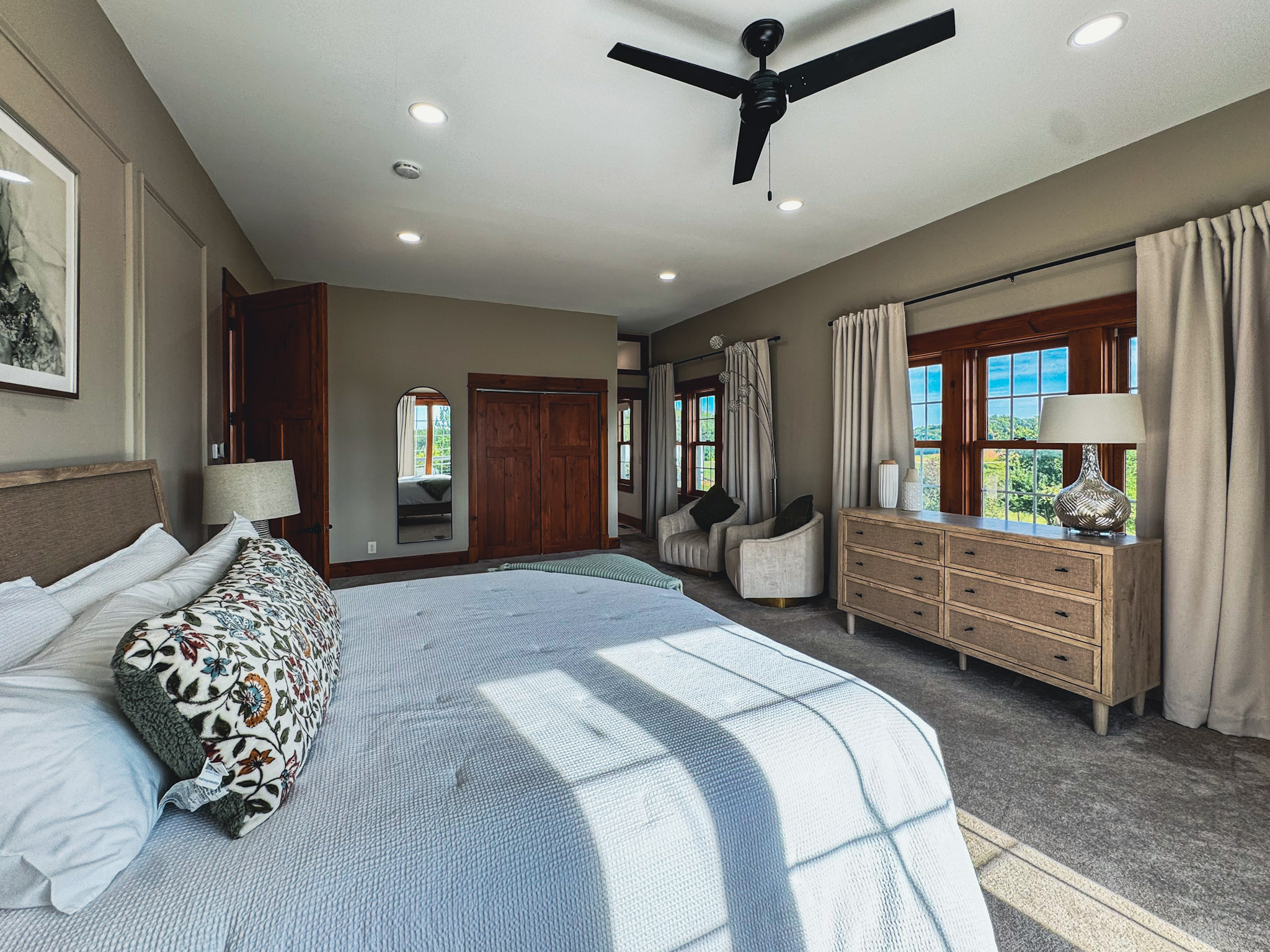 Main-level primary suite with a king bed and seating area.