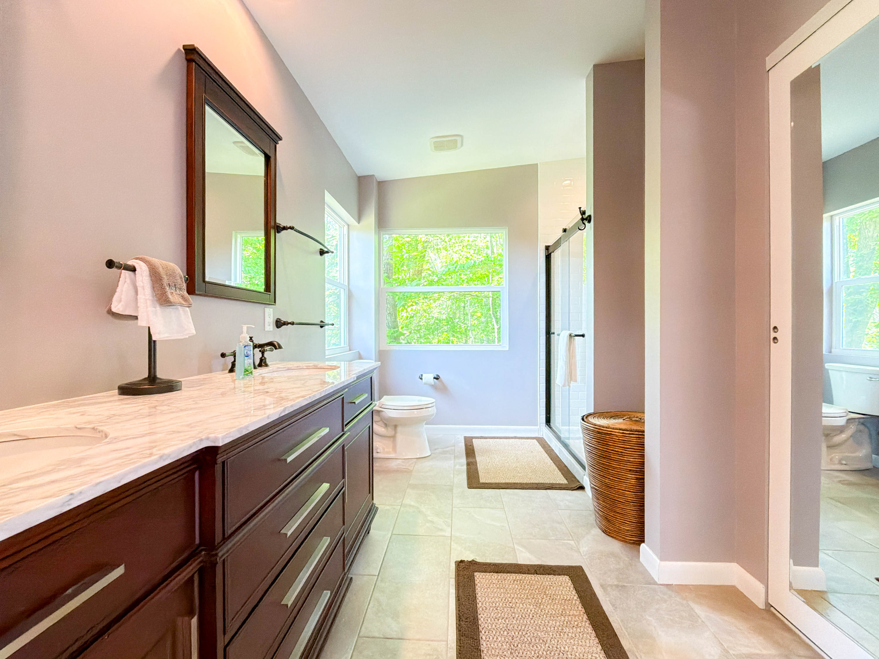 full bathroom in the en-suite master bedroom. Dual vanity sinks, low clearance walk-in shower with glass doors.