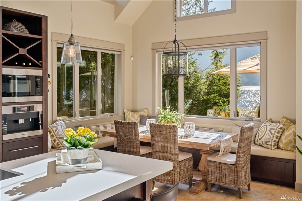 Dining area with ample seating, open to the living room and kitchen, featuring breathtaking views throughout.