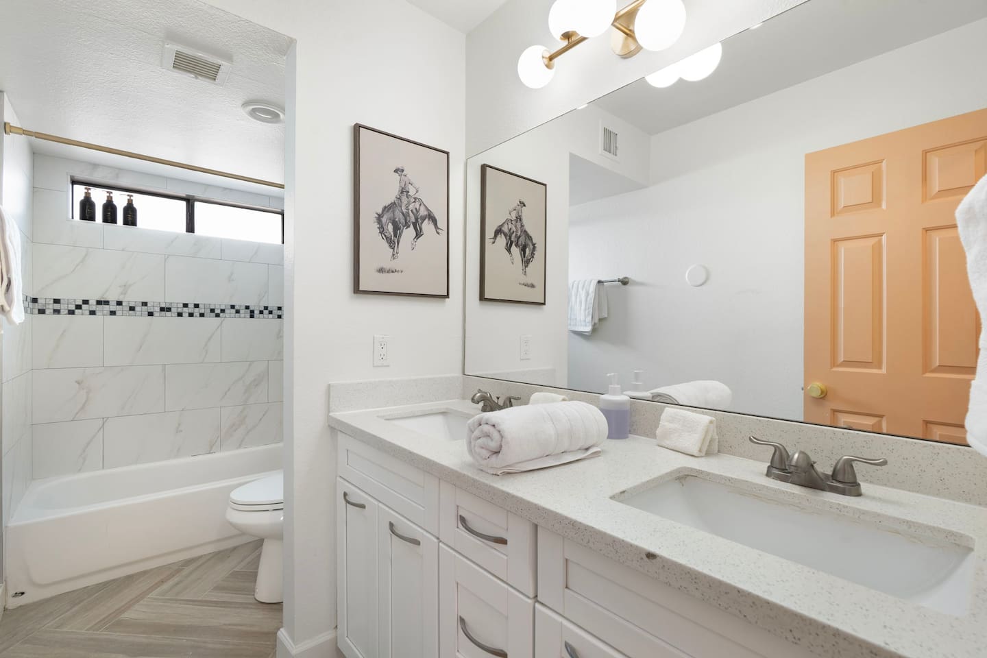 Custom tiled shower with tub and dual vanities.