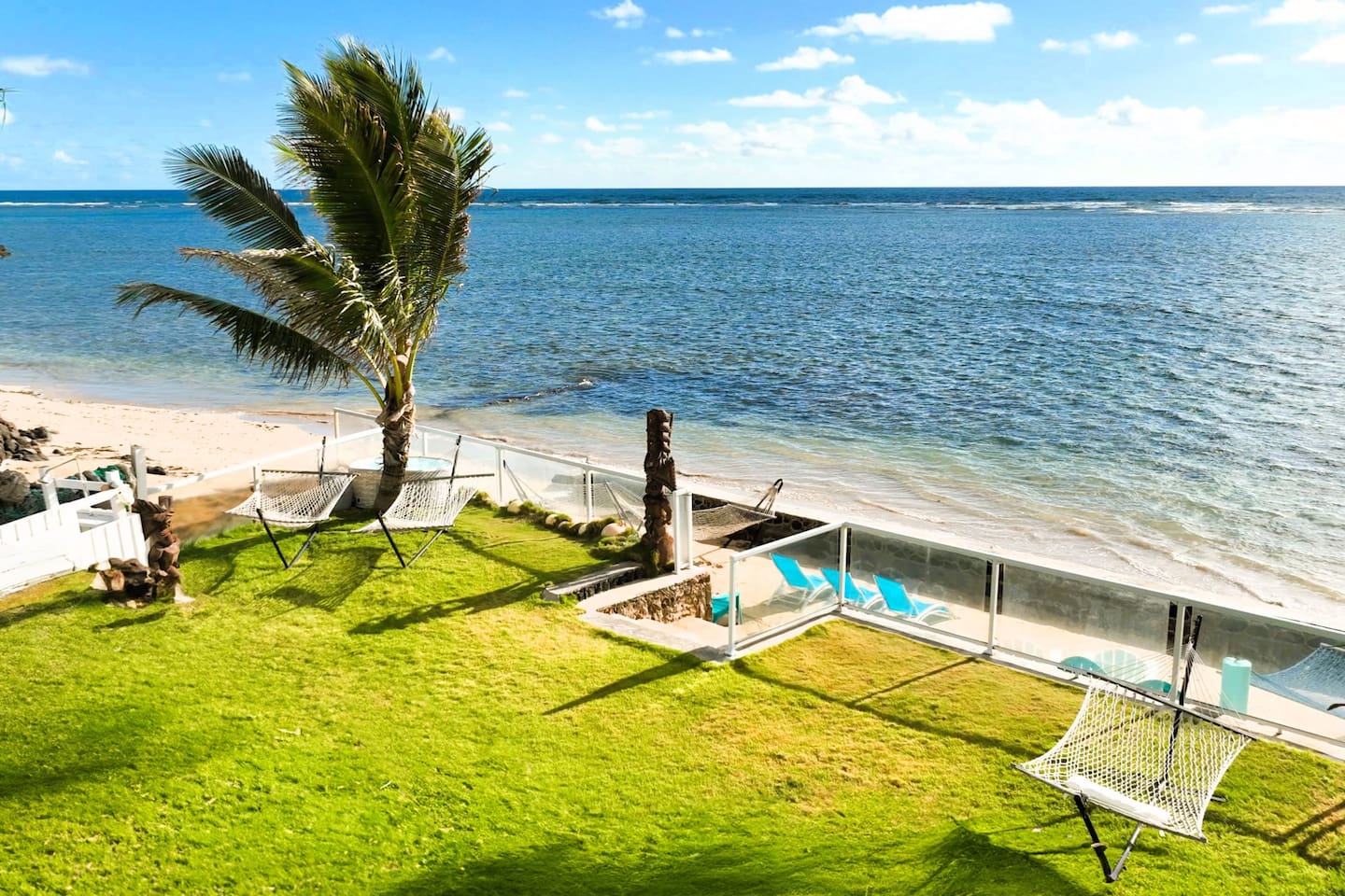 Beachfront Estate with enclosed private beach at the break of dawn with water lily plants, plumeria flower trees and coconut trees