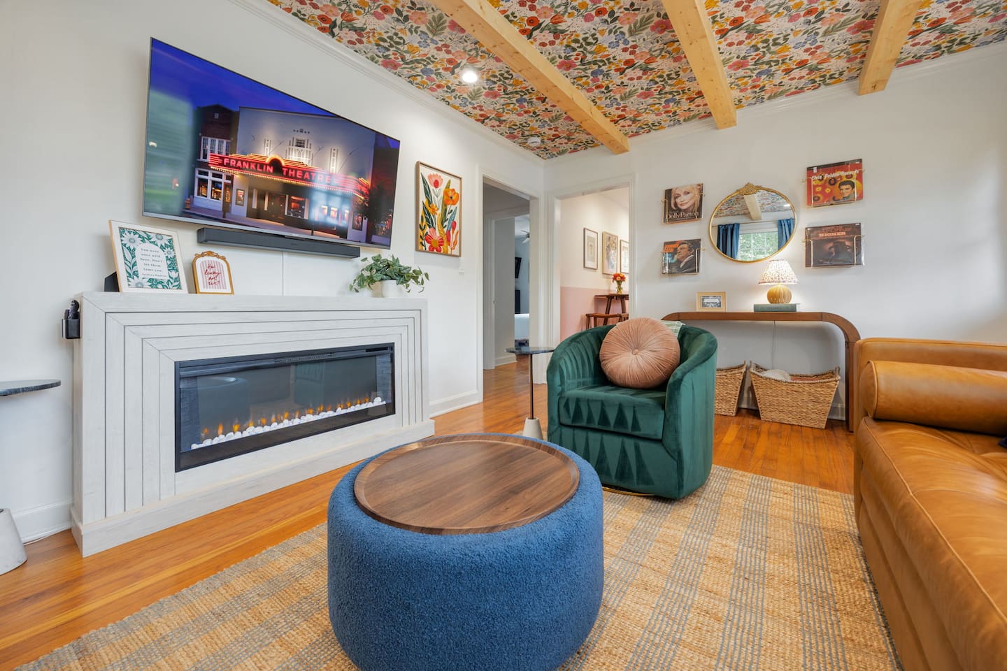 A cozy space to kick your feet up! The living room includes electric fireplace, 55" TV, leather couch with a pull-out bed, small desk, games, & a record player.