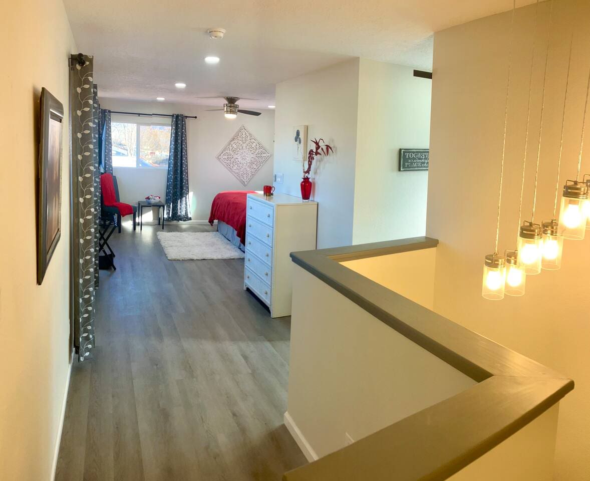 Access to the the upstairs bedroom featuring a comfortable king‑size bed, walk‑in closet, and a private full bathroom. Blackout curtains ensure a restful, uninterrupted sleep.