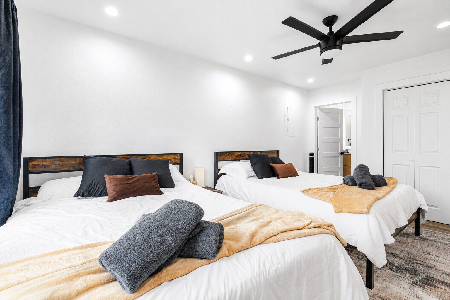 Modern design with two plush beds, soft linens, and inviting natural light.