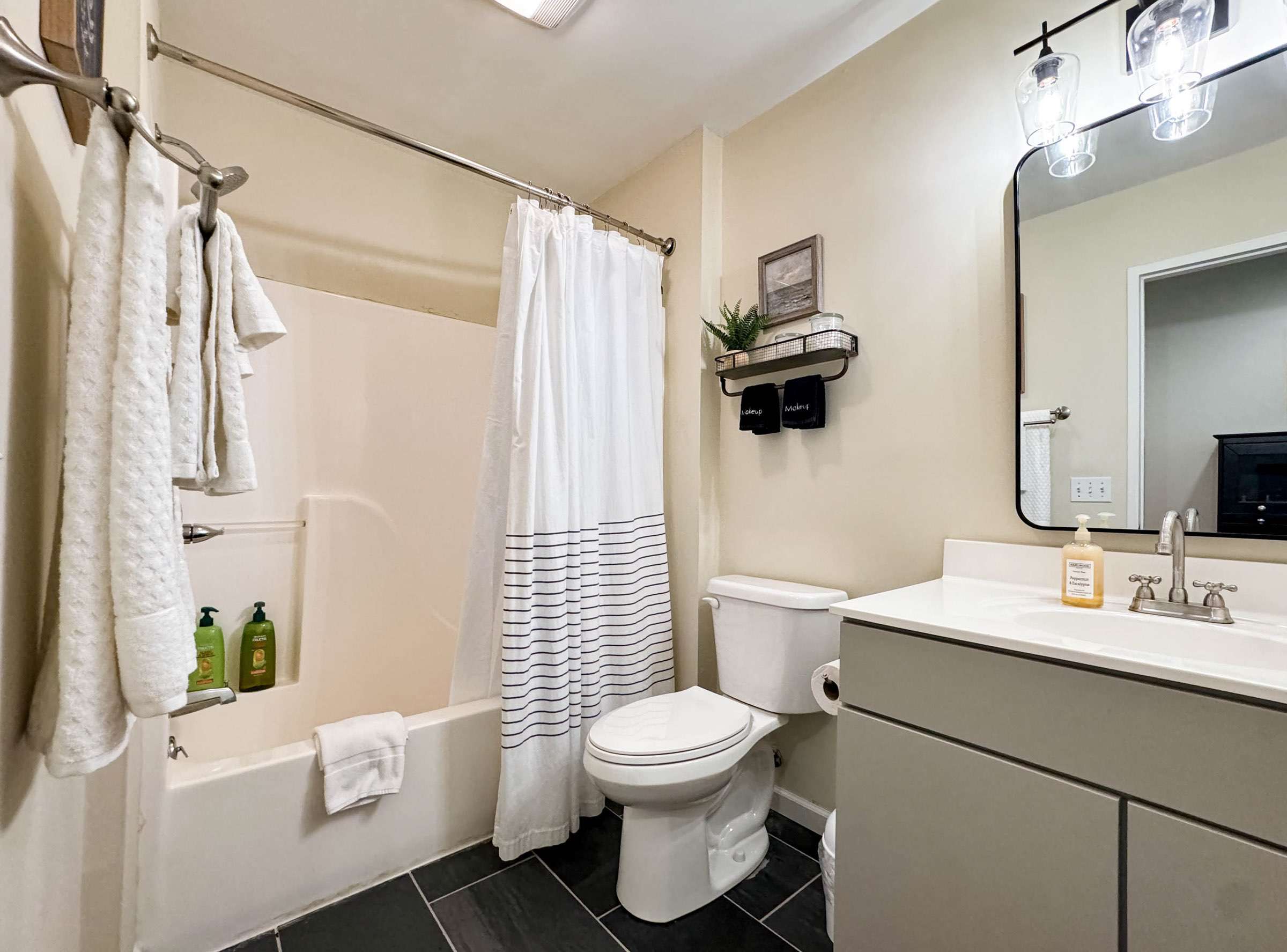 The upstairs bathroom is a shared bathroom for the two upstairs bedrooms. The bathroom features a tub/shower combination, toilet, and sink. 