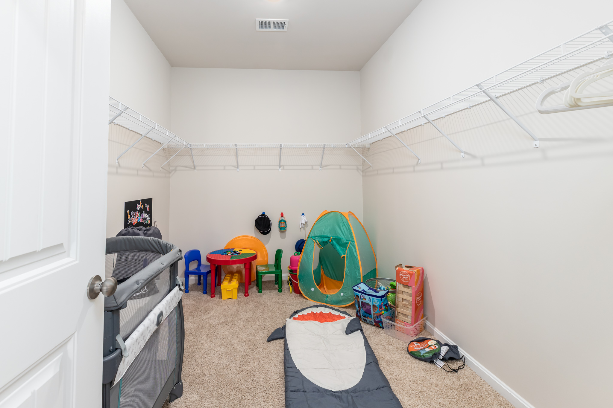 Welcome to the kids' play area tucked within the walk-in closet off the master bedroom! A creative space for little ones to play, imagine, and explore, making use of the closet's cozy nooks and crannies for endless adventures and fun.