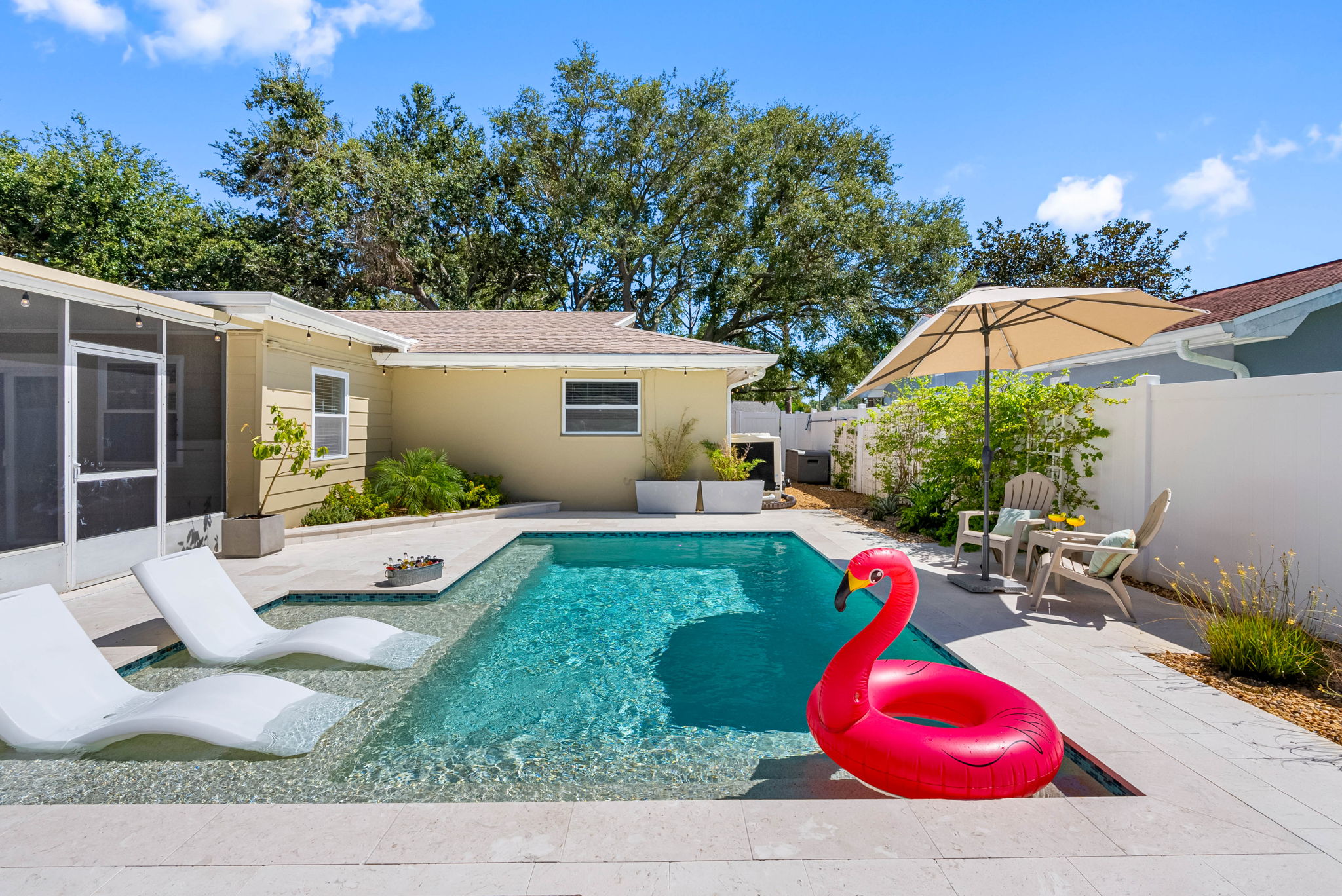Enjoy breezy mornings or relaxing evenings in this spacious screened-in patio overlooking the pool.