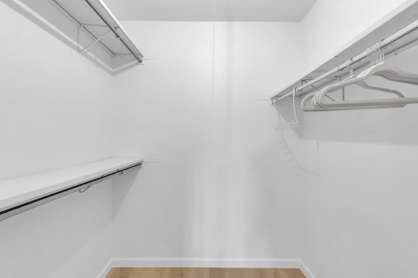 Expansive walk-in closet with abundant clothes storage, shelving, and hangers—perfect for extended stays or families needing extra space.