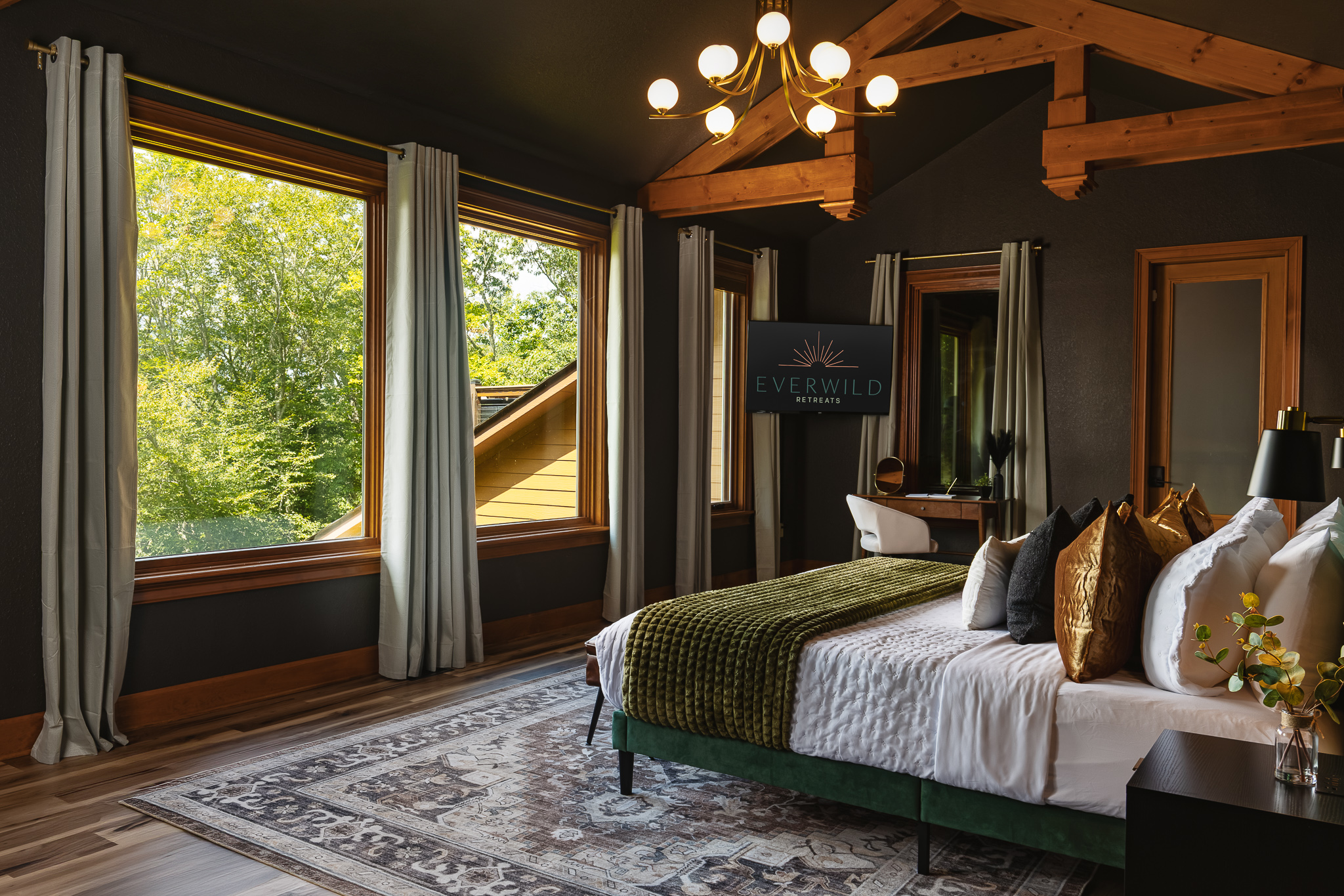 {Bedroom 1} The spacious king suite pairs dramatic wood beams, oversized windows, and cozy designer finishes for a true mountain-retreat feel.