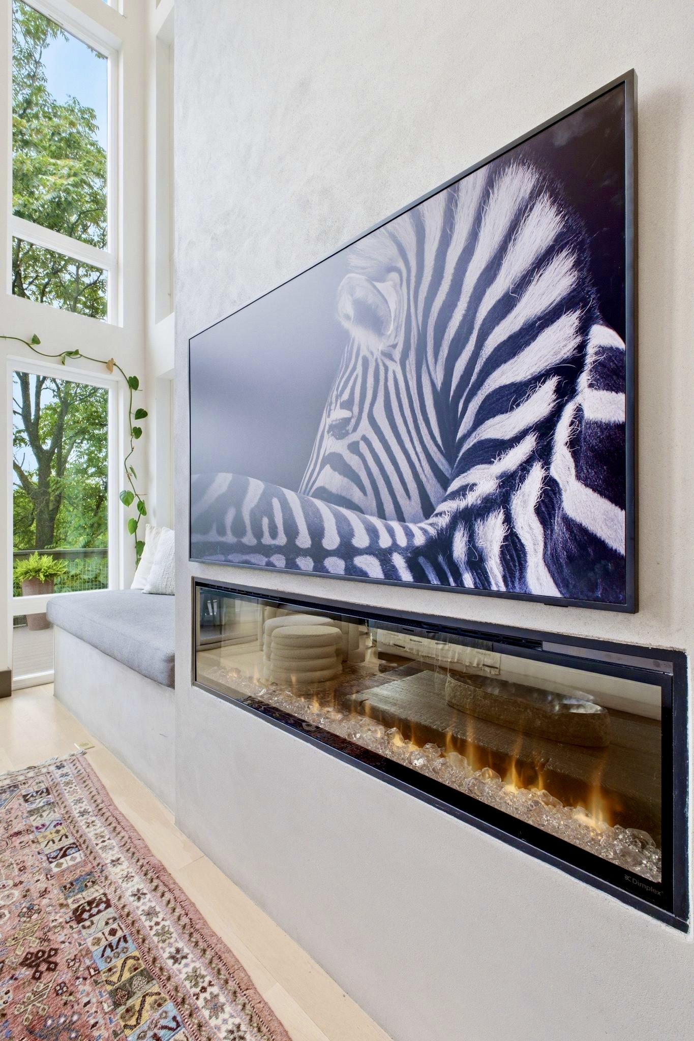 Bold zebra-print wall art anchors this eclectic lounge w/ a Union Jack throw & relaxed seating.

