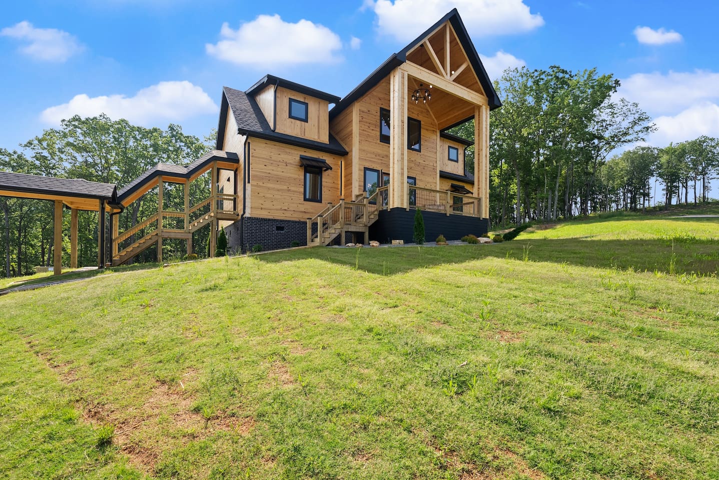 From the gently sloped yard to the sleek carport and stairway entry, every detail here is crafted for convenience and style in a natural setting.