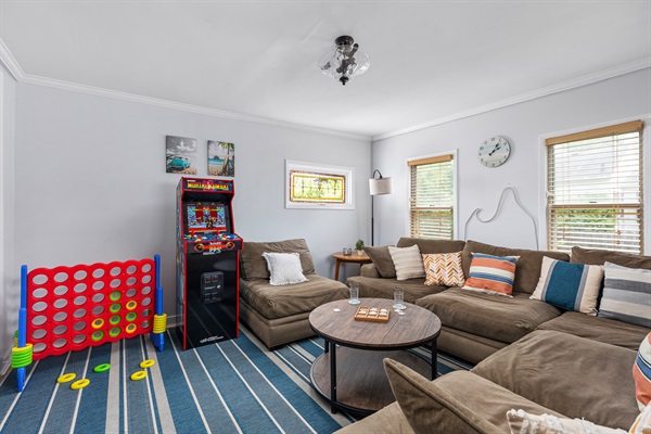 Gather for unforgettable movie nights and friendly competitions in the family room featuring a 75" Smart TV, plush leather seating, a LED fireplace, and a foosball table for nonstop fun.